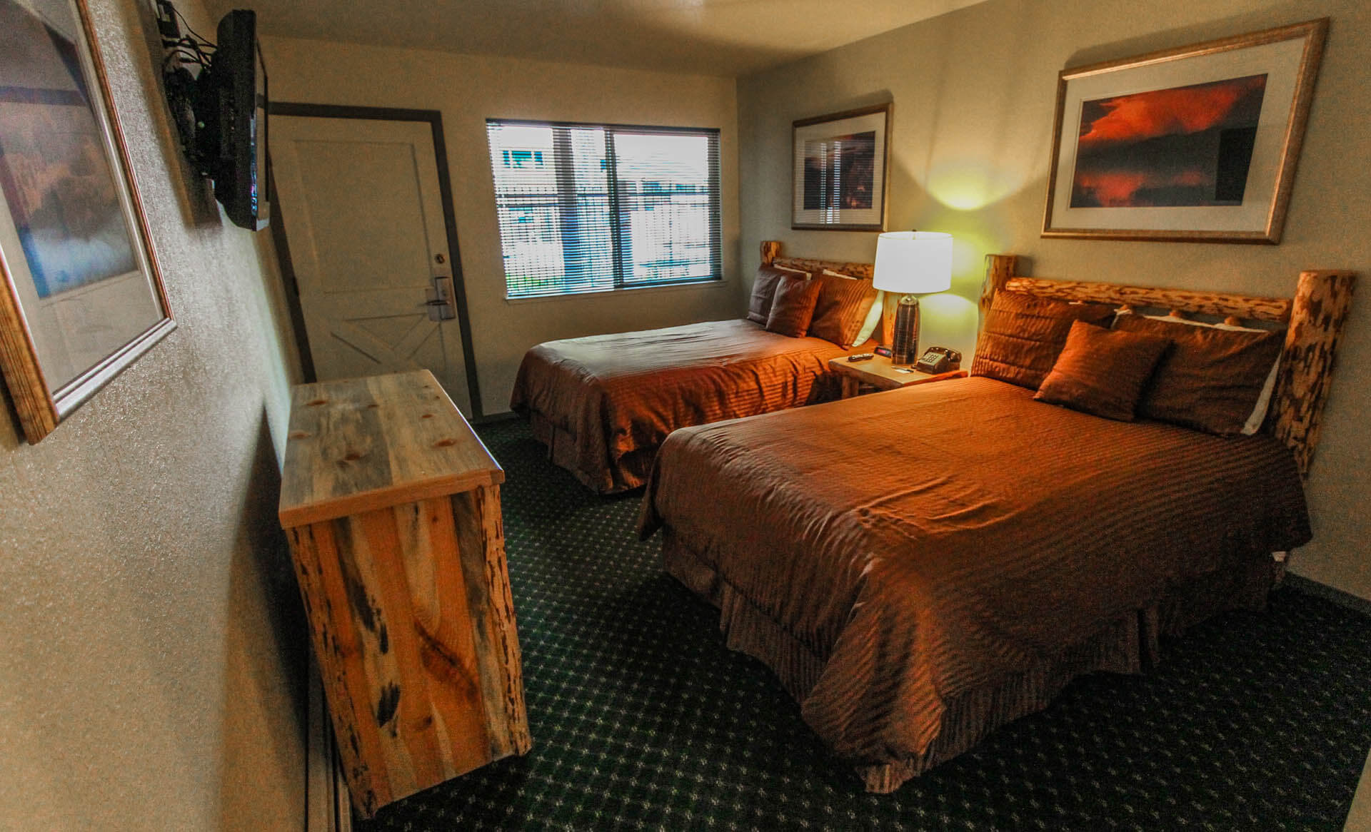 A spacious bedroom with double beds at VRI's The Lodge at Lake Tahoe in California.